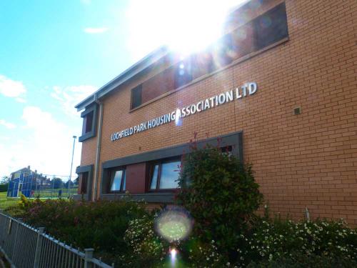 Front of Lochfield Park Housing Association Office with basketball court in background