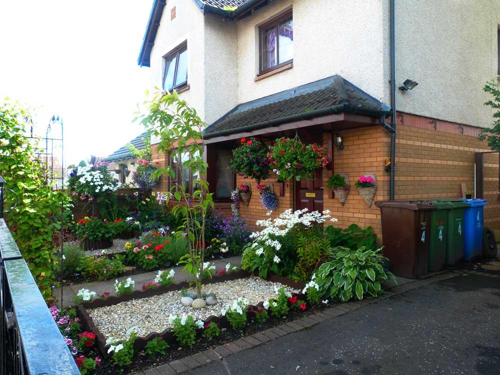 Side View of Front Garden in Lochfield Gardens with flowers and stones